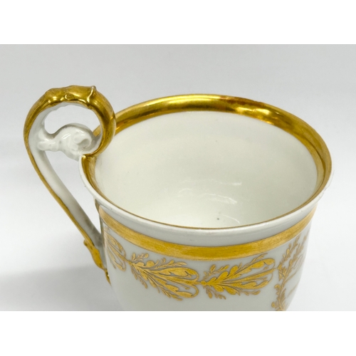 10 - KPM Berlin. An Early 19th Century gilt porcelain cup and saucer. Dein Gluck Mein Wunsch.