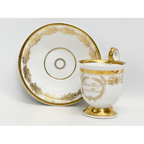 10 - KPM Berlin. An Early 19th Century gilt porcelain cup and saucer. Dein Gluck Mein Wunsch.