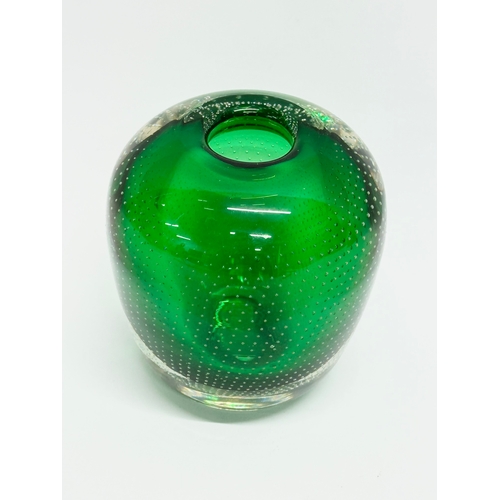 64 - Andries Dirk Copier. A 20th Century Leerdam Glasfabriek emerald green vase, with controlled bubble d... 