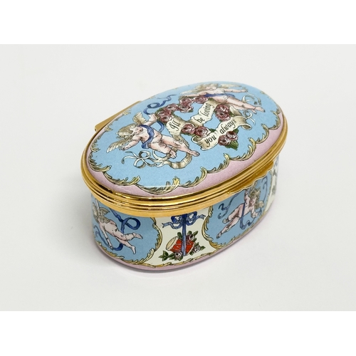 535 - A Halcyon Days Enamels cherub musical trinket box with case.  (1)