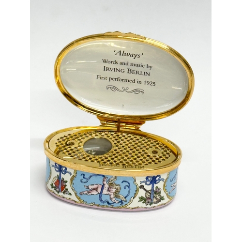 535 - A Halcyon Days Enamels cherub musical trinket box with case.  (1)