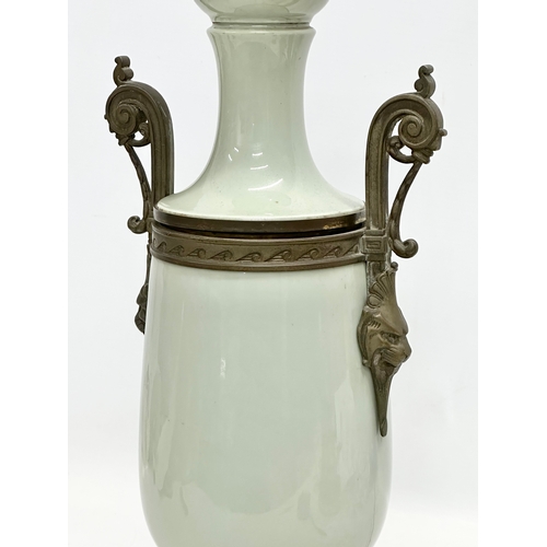 34 - A Late 19th Century French celadon glazed converted oil lamp/table lamp, with brass mounts. Raised o... 