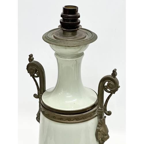 34 - A Late 19th Century French celadon glazed converted oil lamp/table lamp, with brass mounts. Raised o... 