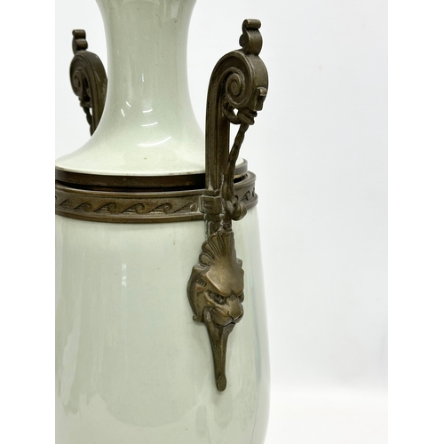 34 - A Late 19th Century French celadon glazed converted oil lamp/table lamp, with brass mounts. Raised o... 