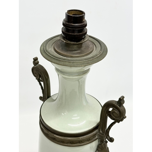 34 - A Late 19th Century French celadon glazed converted oil lamp/table lamp, with brass mounts. Raised o... 