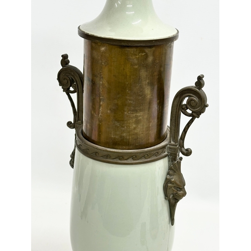 34 - A Late 19th Century French celadon glazed converted oil lamp/table lamp, with brass mounts. Raised o... 