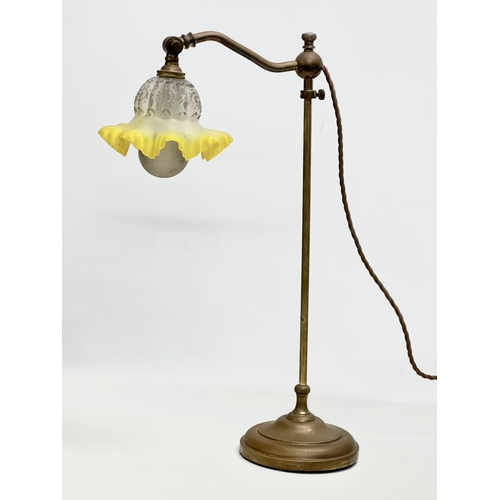 183 - An Early 20th Century brass rise and fall table lamp, with original glass shade. 51cm