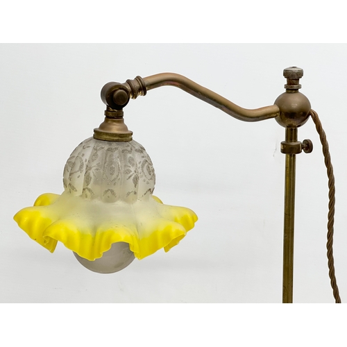 183 - An Early 20th Century brass rise and fall table lamp, with original glass shade. 51cm