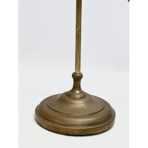 183 - An Early 20th Century brass rise and fall table lamp, with original glass shade. 51cm