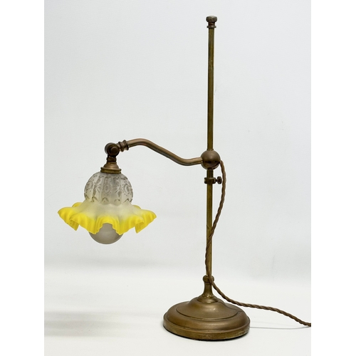 183 - An Early 20th Century brass rise and fall table lamp, with original glass shade. 51cm