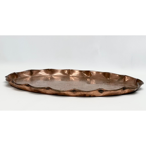 185 - J.F.Pool of Hayle. An Arts & Crafts copper tray with scalloped rim and impressed koi fish design. Ci... 