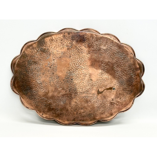 185 - J.F.Pool of Hayle. An Arts & Crafts copper tray with scalloped rim and impressed koi fish design. Ci... 