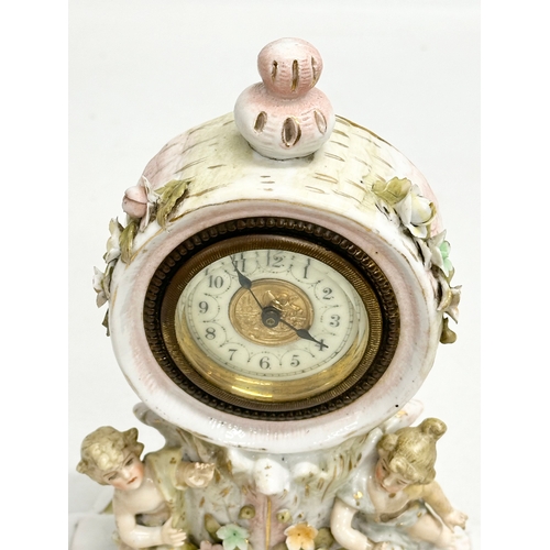 39 - Sitzendorf Porcelain. A Late 19th Century figural mantle clock. Circa 1880-1900. 14x10x20cm