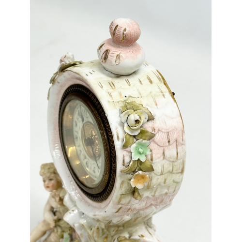 39 - Sitzendorf Porcelain. A Late 19th Century figural mantle clock. Circa 1880-1900. 14x10x20cm