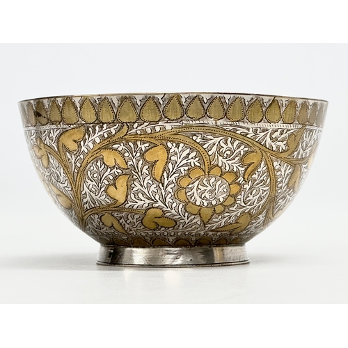 296 - A 19th Century Middle Eastern engraved brass and silver overlay bowl. 14x7cm