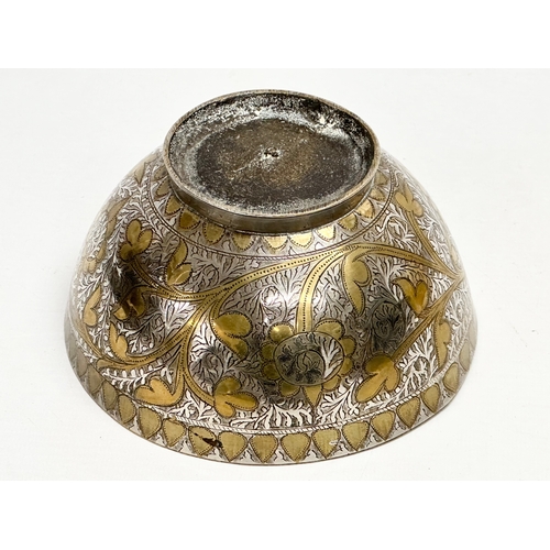 296 - A 19th Century Middle Eastern engraved brass and silver overlay bowl. 14x7cm