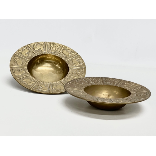 561 - A pair of Mid 20th Century Zodiac brass 12 sessions ashtray/bowls. 19x4cm