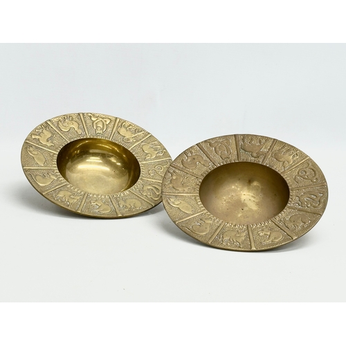 561 - A pair of Mid 20th Century Zodiac brass 12 sessions ashtray/bowls. 19x4cm