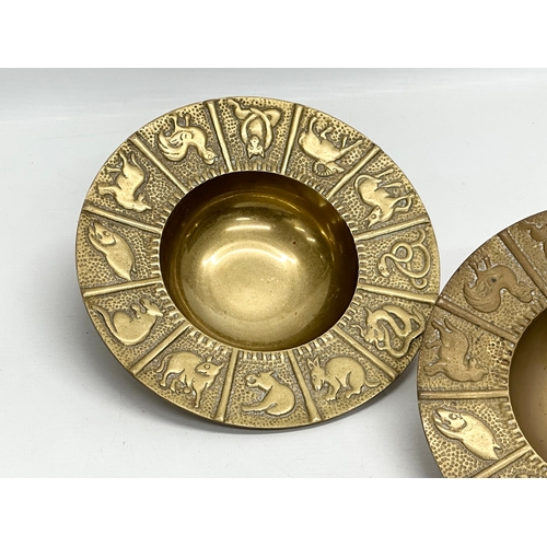 561 - A pair of Mid 20th Century Zodiac brass 12 sessions ashtray/bowls. 19x4cm