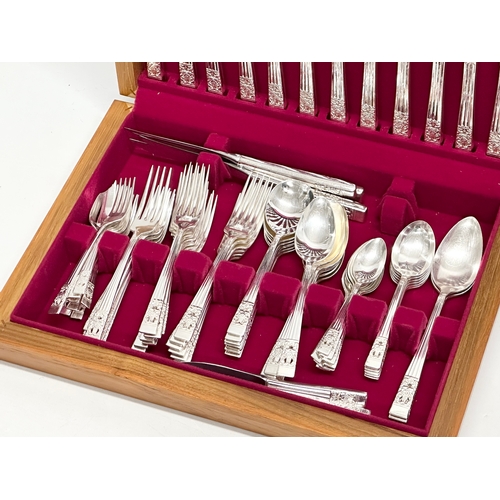 571 - A vintage canteen of cutlery/cutlery set in teak case. 41x29x7cm