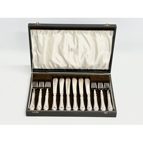 438 - Mappin & Webb. Early 20th Century silver plated cutlery set in case. Fish knives 22cm. Forks 19cm. C... 