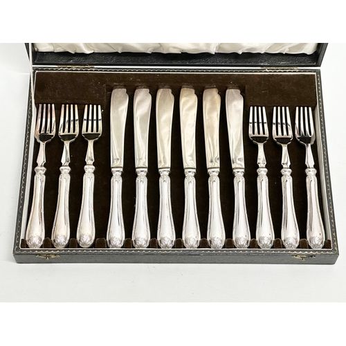 438 - Mappin & Webb. Early 20th Century silver plated cutlery set in case. Fish knives 22cm. Forks 19cm. C... 