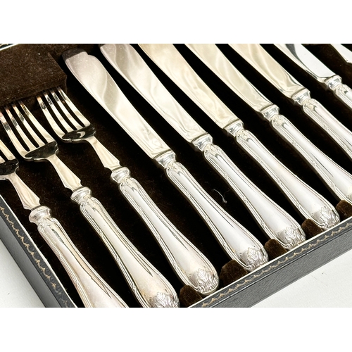 438 - Mappin & Webb. Early 20th Century silver plated cutlery set in case. Fish knives 22cm. Forks 19cm. C... 