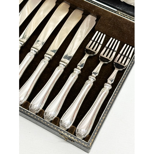 438 - Mappin & Webb. Early 20th Century silver plated cutlery set in case. Fish knives 22cm. Forks 19cm. C... 