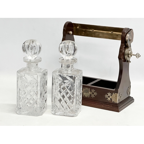 130 - A vintage tantalus and decanters. 26x30cm