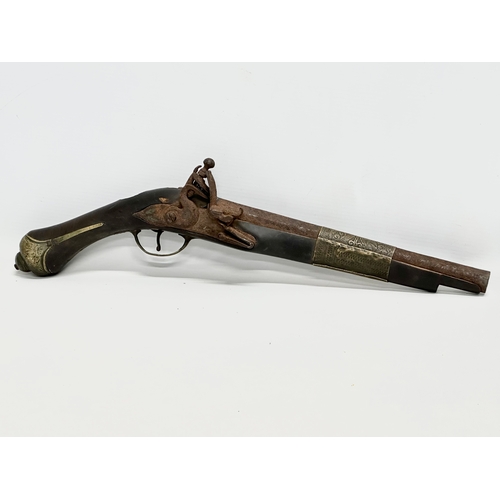 278 - A 19th Century Turkish percussion cap pistol and a British gunpowder flask. 44cm