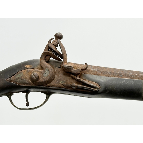 278 - A 19th Century Turkish percussion cap pistol and a British gunpowder flask. 44cm