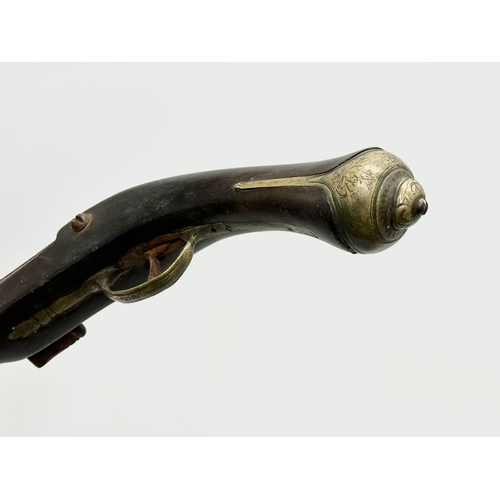 278 - A 19th Century Turkish percussion cap pistol and a British gunpowder flask. 44cm