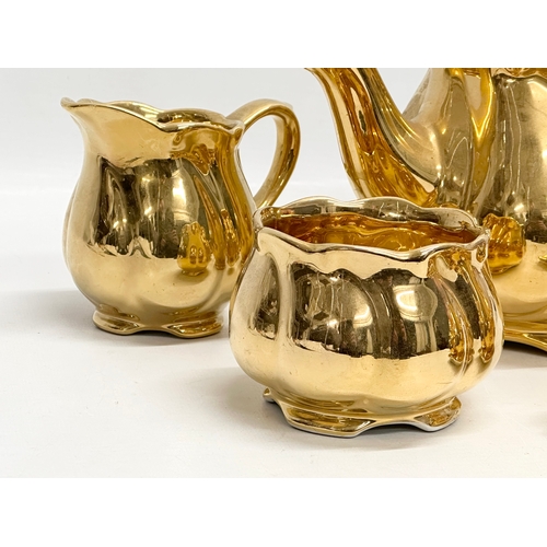 811 - A Mid 20th Century Royal Winton “Golden Age” part tea service. Teapot, crust set, milk jug and sugar... 