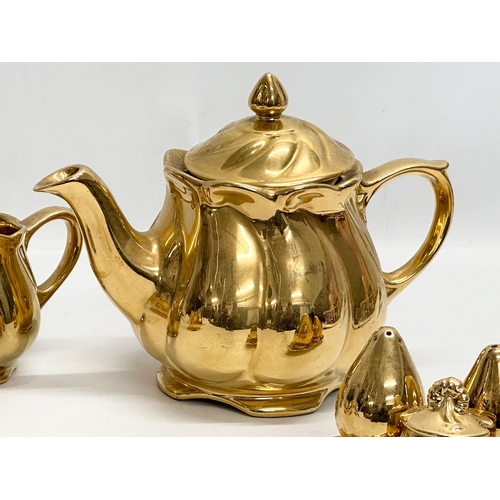 811 - A Mid 20th Century Royal Winton “Golden Age” part tea service. Teapot, crust set, milk jug and sugar... 