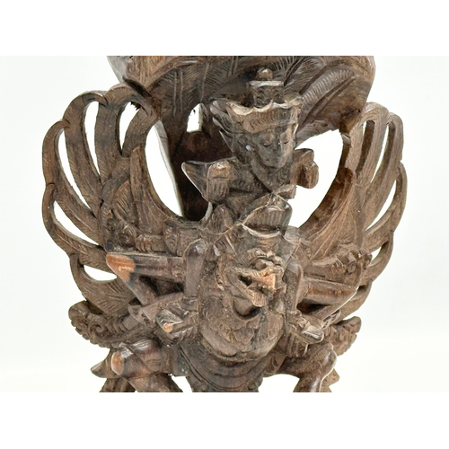 293 - An Early 20th Century carved Vishnu and Garuda statue. 18cm