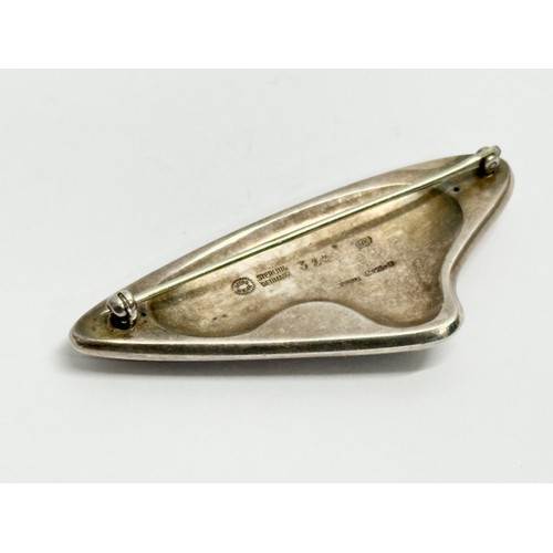 712E - Georg Jensen. A Danish silver brooch. Designed by Henning Koppel. 7cm.    (9)