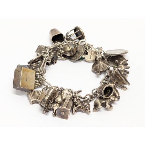 865 - A heavy silver charm bracelet. 78g