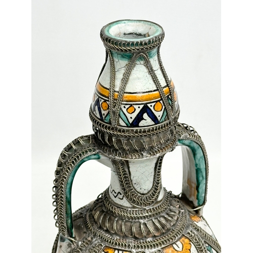 309A - A large signed Moroccan pewter bound pot with cover. 36cm