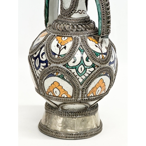 309A - A large signed Moroccan pewter bound pot with cover. 36cm