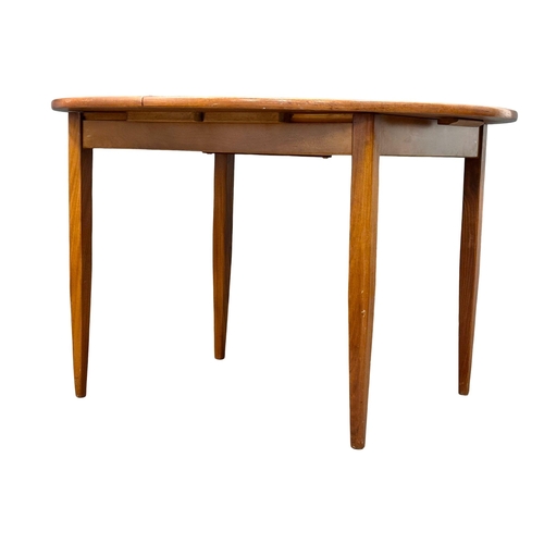 142 - A Mid Century teak extending dining table and 4 chairs. Closed 114.5x74.5cm. Open 145x114:5x74cm.(5)