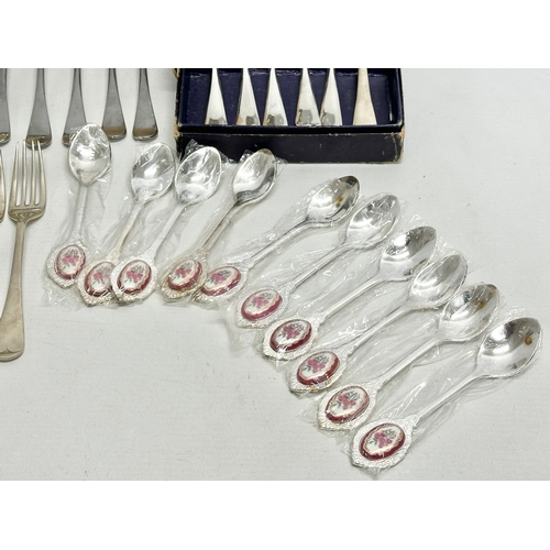 841 - A collection of silver plated cutlery and an Capodimonte miniature flower basket. Including vintage ... 