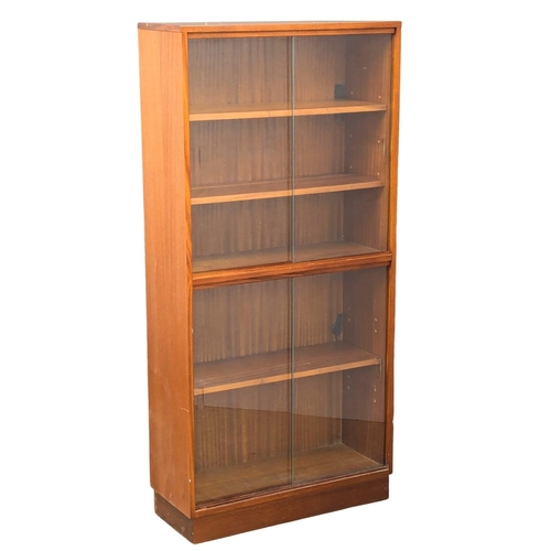 921 - A Mid Century teak bookcase with 4 sliding glass doors. 69x28x144cm (4)