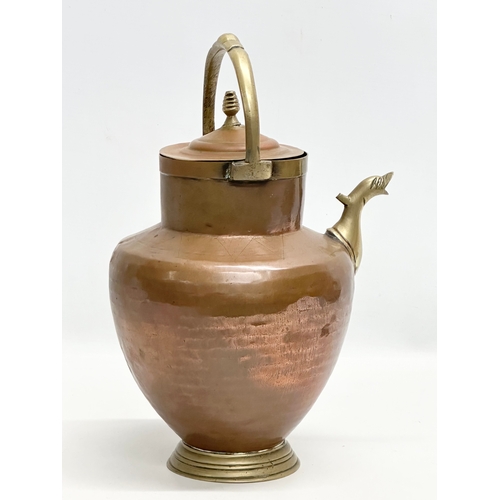 396 - An Early 20th Century Italian copper and brass water pitcher. 22x17x32cm