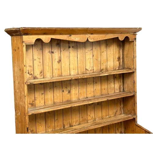 121 - A large Late 19th Century Irish pine farmhouse kitchen dresser. 145x45x201.5cm