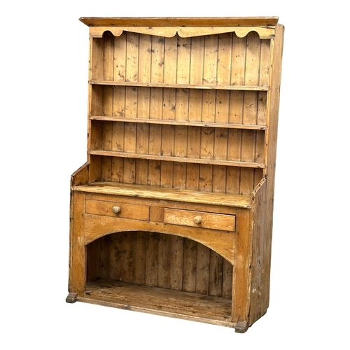 121 - A large Late 19th Century Irish pine farmhouse kitchen dresser. 145x45x201.5cm