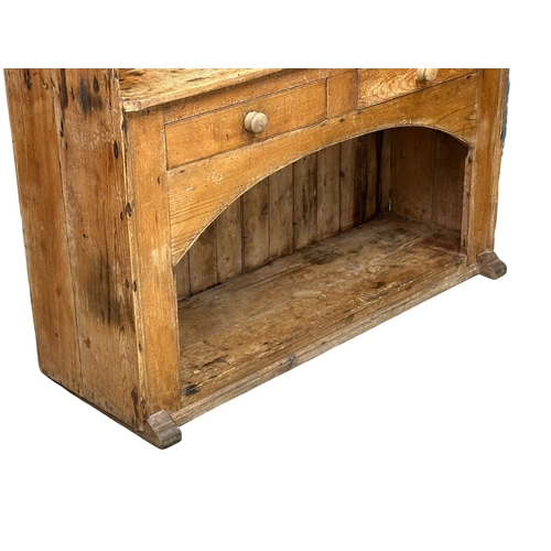 121 - A large Late 19th Century Irish pine farmhouse kitchen dresser. 145x45x201.5cm