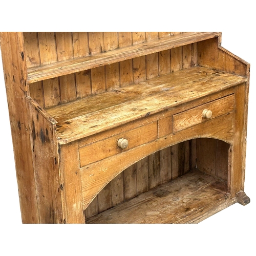 121 - A large Late 19th Century Irish pine farmhouse kitchen dresser. 145x45x201.5cm