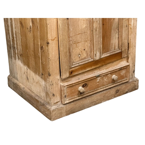 122 - A large Late 19th Century Victorian pine single door cupboard with drawer. 84x:68x204cm