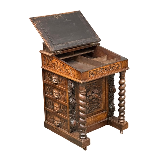 124 - A 19th Century Victorian carved oak Davenport desk, with leather top and Man of the Forest decoratio... 