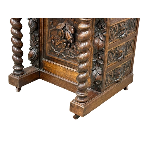 124 - A 19th Century Victorian carved oak Davenport desk, with leather top and Man of the Forest decoratio... 